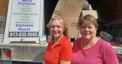 The West Carleton Food Access Centre's, from left, Karin Smith and Pamela Ross pose for a photo at last year's colossal book sale. Photo by Jake Davies
