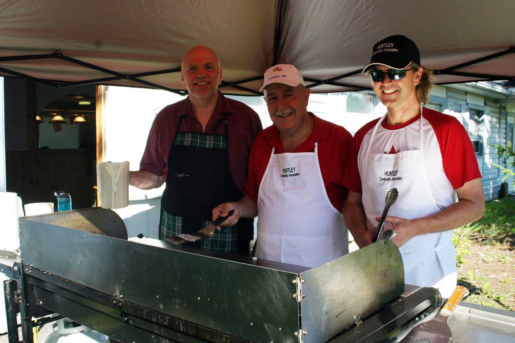 Too many cooks spoil the brew. From left, Senator Vern White, Coun. Eli El-Chantiry and HCA member Hanns Baader cook pancakes at the HCA Canada Day Seniors Breakfast. Photo by Jake Davies﻿