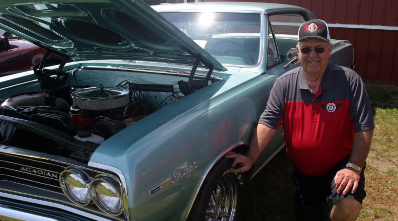 Carp Show 'n Shine's Glen Byrne poses beside his '65 Beaumont Saturday morning at the last show he will organize. Photo by Jake Davies