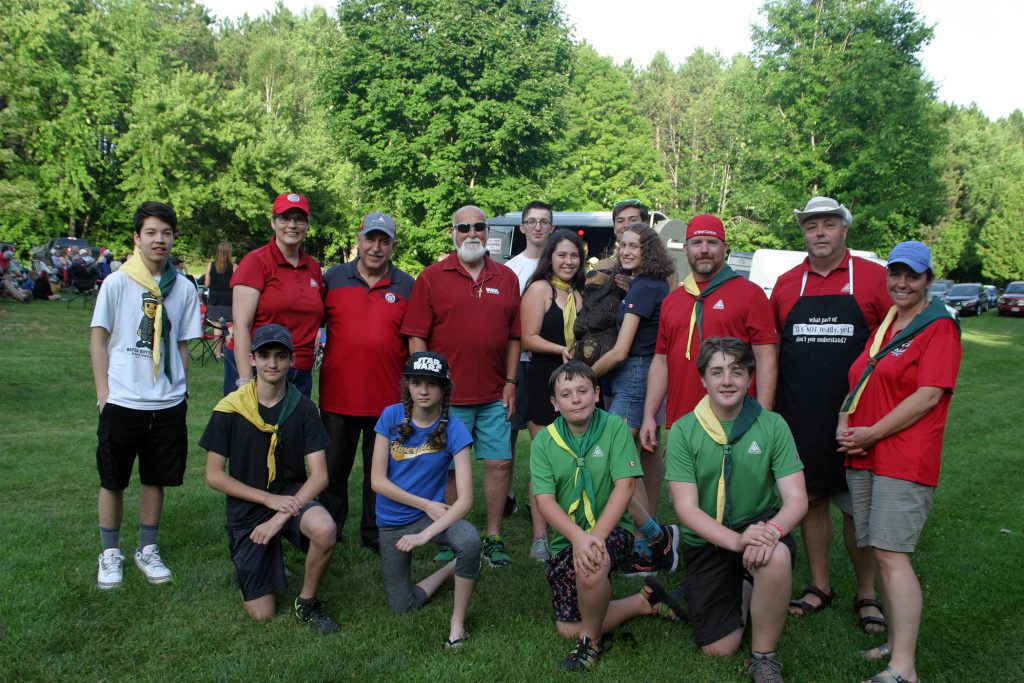 Coun. Eli El-Chantiry and Wast Management's Wayne French pose with the West Carleton First Scouts who were providing the evening's barbecue. Photo by Jake Davies