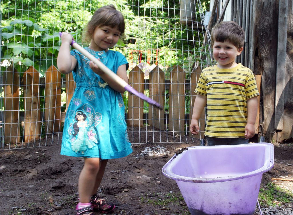 Sadie Wood and Samuel Small are happy to help out at the farm. Photo by Jake Davies