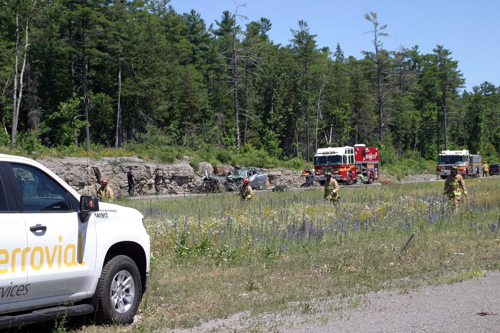 Firefighters comb the collision scene for debris. Photo by Jake Davies