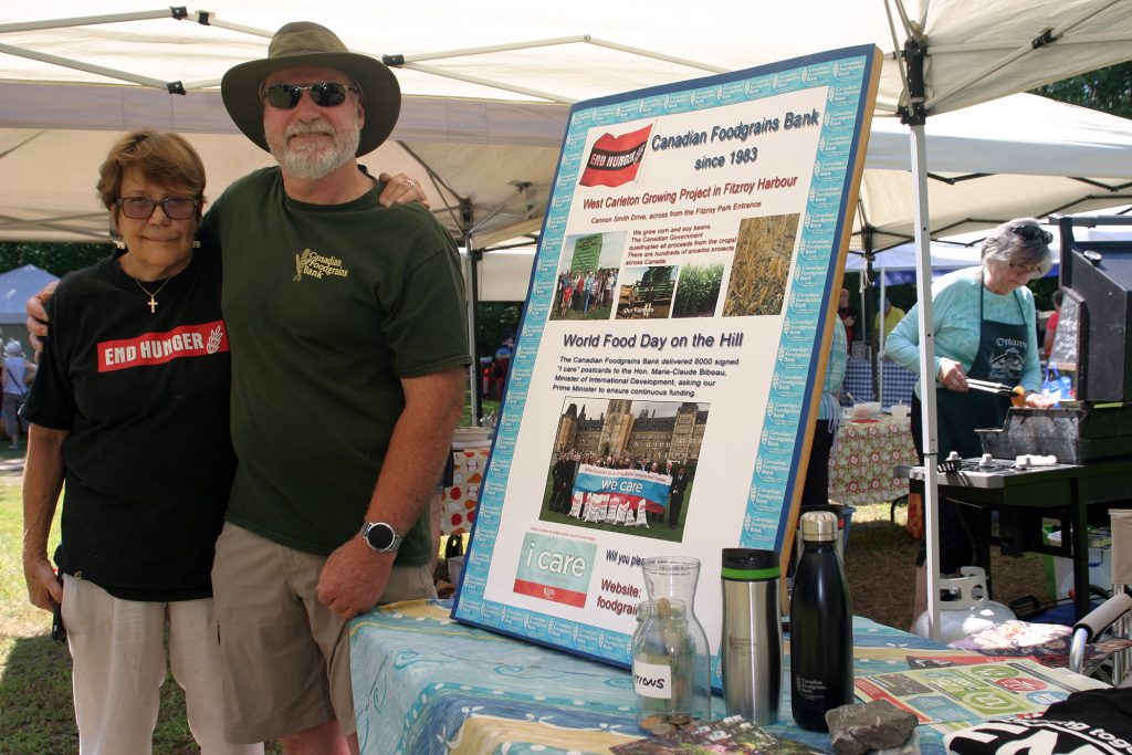 From left, Lisa Probst and Gary Weir spread the word of the West Carleton Foodgrains Bank Growing Project at the Saturday, July 13 Constance Bay Community Market. Photo by Jake Davies.
