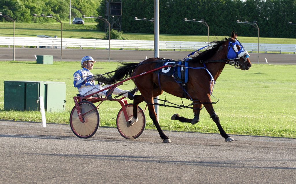 Driver Rodney LaFramboise and Silverado at the track June 23. Photo by Jake Davies