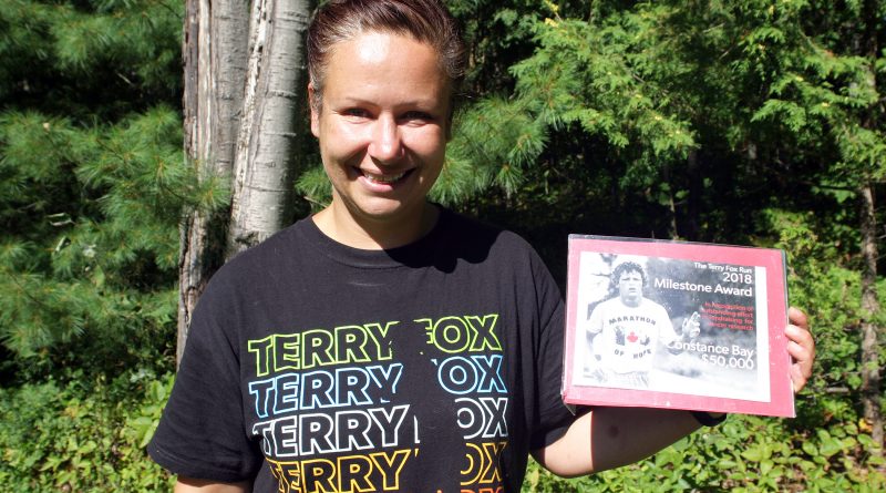 West Carleton Terry Fox Run Mila Dolezalova shows off this year's t-shirt and West Carleton's 2018 Milestone Award all in photo. Photo by Jake Davies
