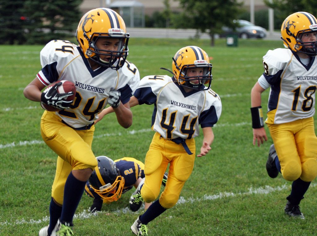 From left, Wolverines tailback Cayden Clement-Martins, cornerback Charles Parks and quarterback Connor Besley head down field on a long run. Photo by Jake Davies