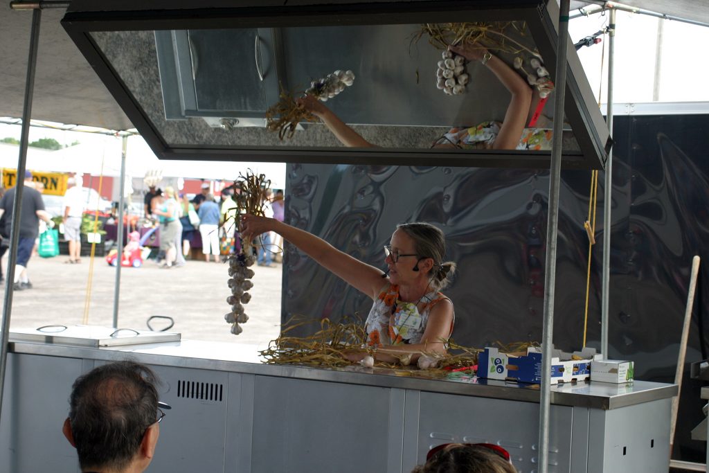 Catherine Cheff gives a workshop on garlic braiding at the Carp Farmers' Market Garlic Festival last Sunday. Photo by Jake Davies