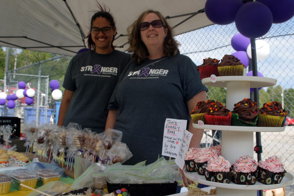 From left, Liam's nurse Rachel Moyes and EA Dianne Bates volunteered their time to run the bake sale. Photo by Jake Davies