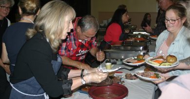 From left, MPP Dr. Merrilee Fullterton serves up some stuffing while Coun. Eli El-Chantiry slices up some roast beef. Photo by Jake Davies