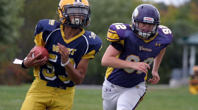Wolverine quarterback Keegan Brunet outruns a Gatineau tackler during a Sept. 1 NCAFA game. Brunet is competing at the World Youth Football Championship in Ohio this week and was named to the NCAFA All-Star team yesterday, Photo by Jake Davies