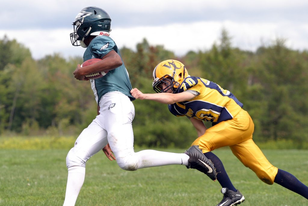 Wolverine defender Luca Elfer-Murphy was able to reel in the Eagle runner for a touchdown saving tackle. Photo by Jake Davies