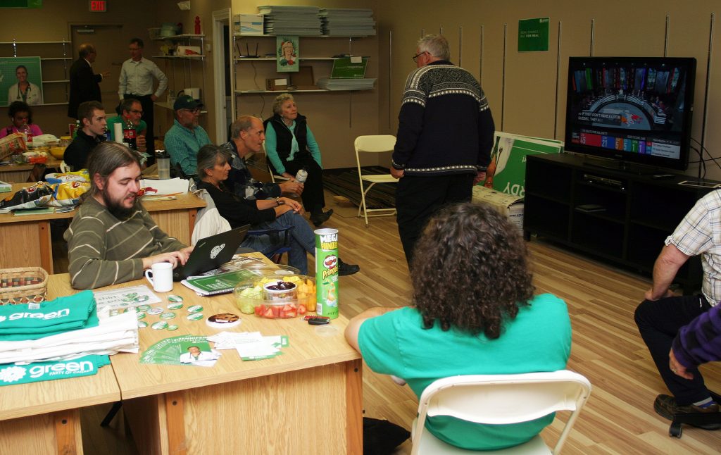 Kanata-Carleton Green Party supporters watch coverage of the election from their heaquarters. Photo by Jake Davies