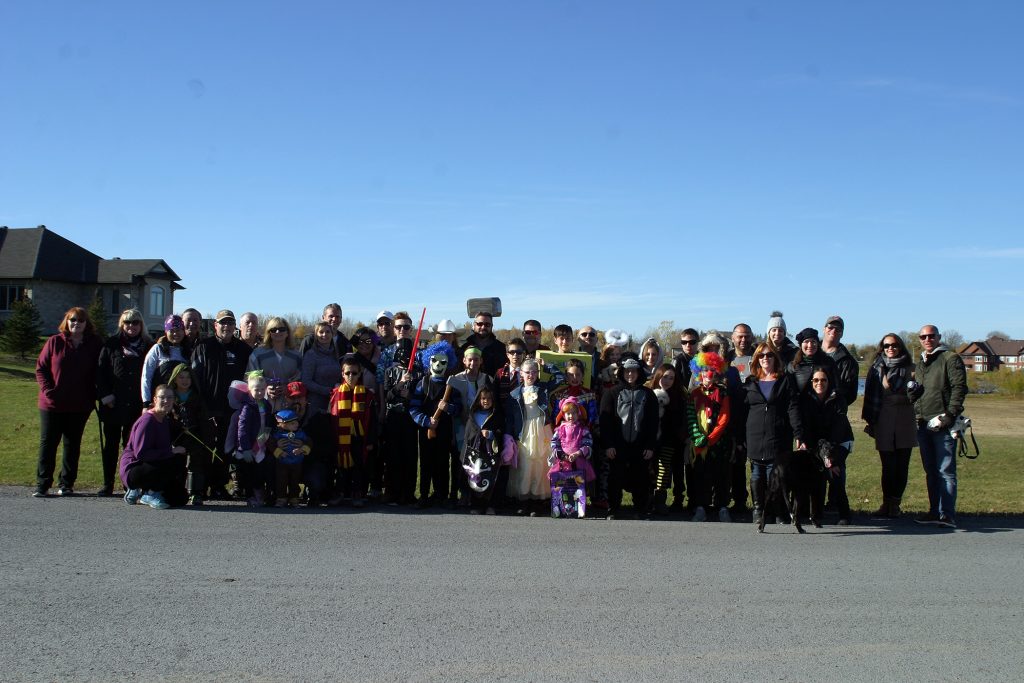 The kids (and parents) of the West Lake community near Carp pose for a photo before heading out on their annual Hallowe'en Parade Saturday. Photo by Jake Davies﻿