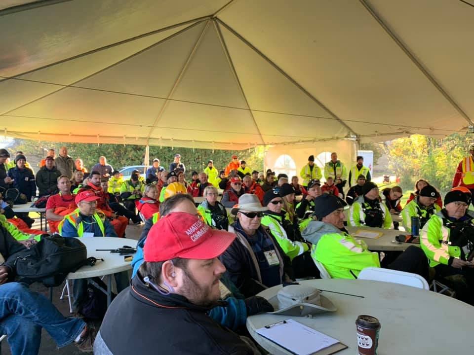 Volunteers gather for a debrief following the emergency response mock drill. Courtesy Eli El-Chantiry