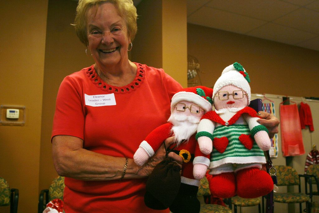 Eleanor Reynaud shows off some of the toys the country knitters have made and donated. Photo by Jake Davies