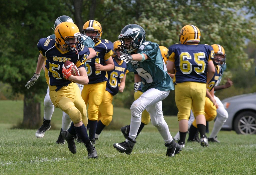 Running back Owen Redmond and the mosquito Wolverines finished the season with a 2-6 record. Photo by Jake Davies