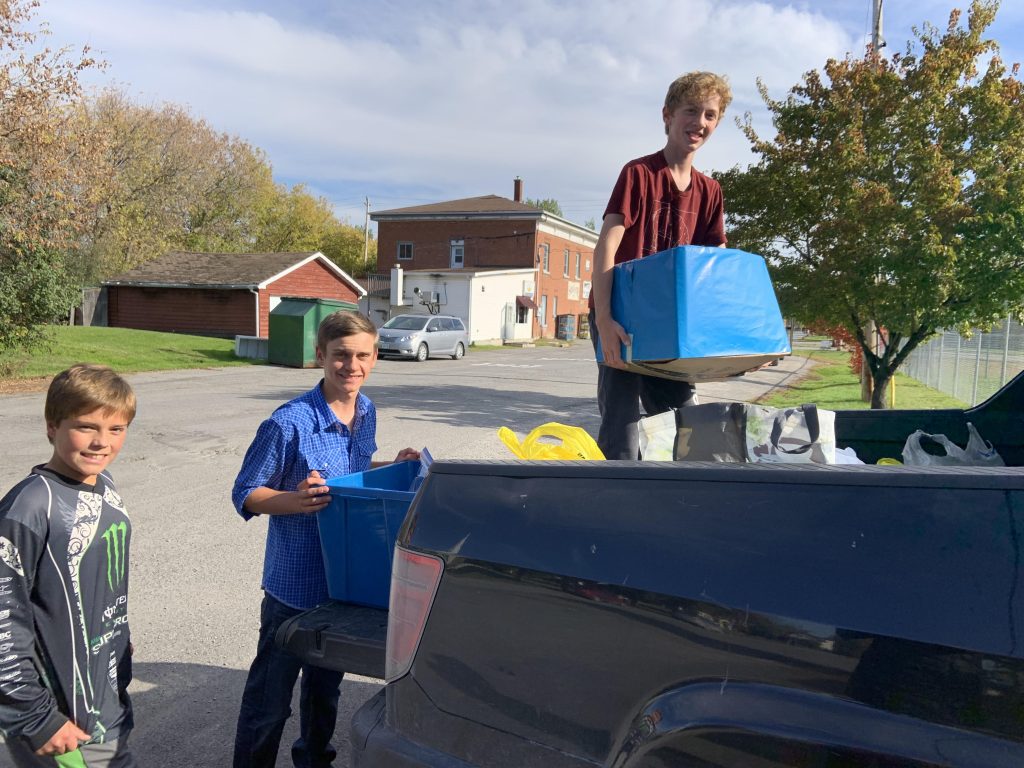 Tobin Mosley, Carl Graham and Cory Hunt help load up a truck with food donations. Courtesy St. Michael's