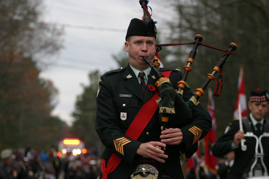 Highlander Chris Reasbeck pipes during the veterans parade. Photo by Jake Davies