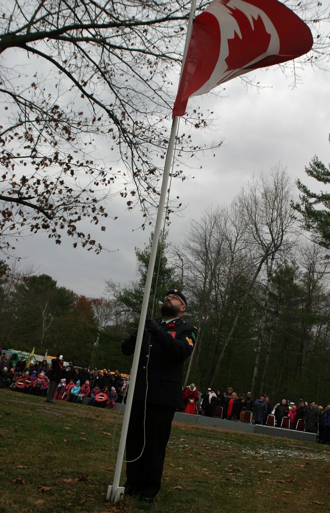 Garrison Petawawa Master Corporal Nathan Pettigrew raises the flag. Photo by Jake Davies