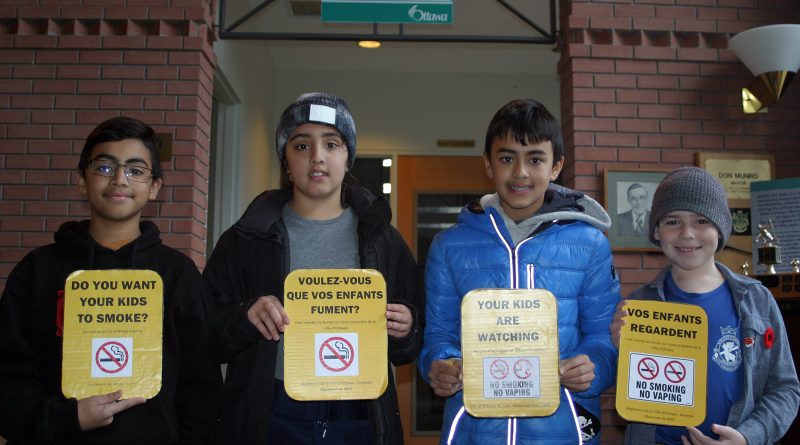 From left, Kieve, Saskia and Alexi Janoska and Austin White, team RoboCrew, with their no smoking signs, part of their FIRST LEGO League City Shaping project. Photo by Jake Davies