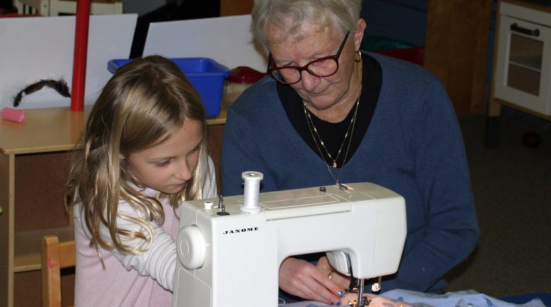 Cherith Cook shows Charlotte MacIsaac how to use a sewing maching at the So You Can Sew event Nov. 7. Photo by Jake Davies