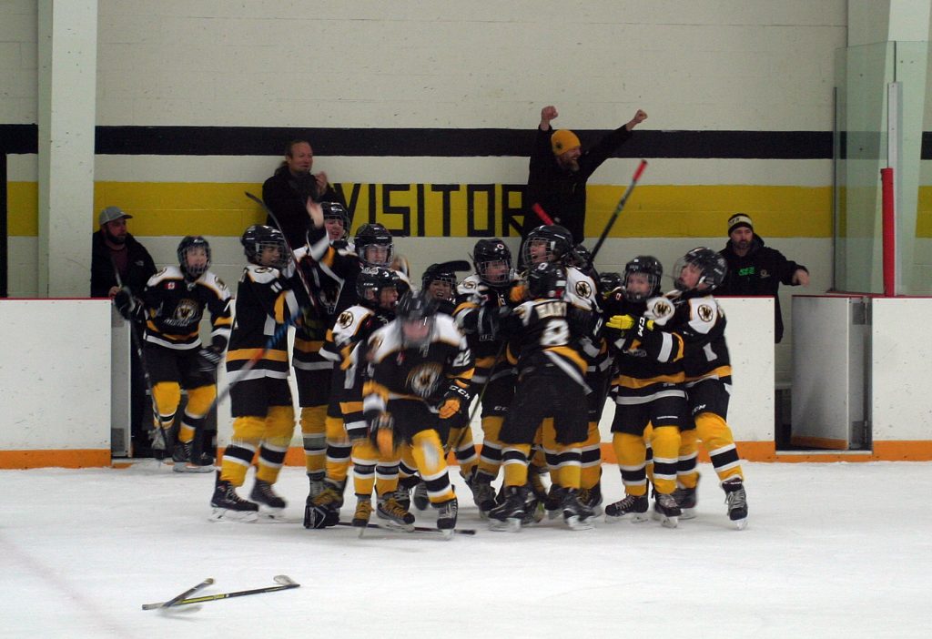 The Warriors celebrate after scoring in overtime to win the championship. Photo by Jake Davies
