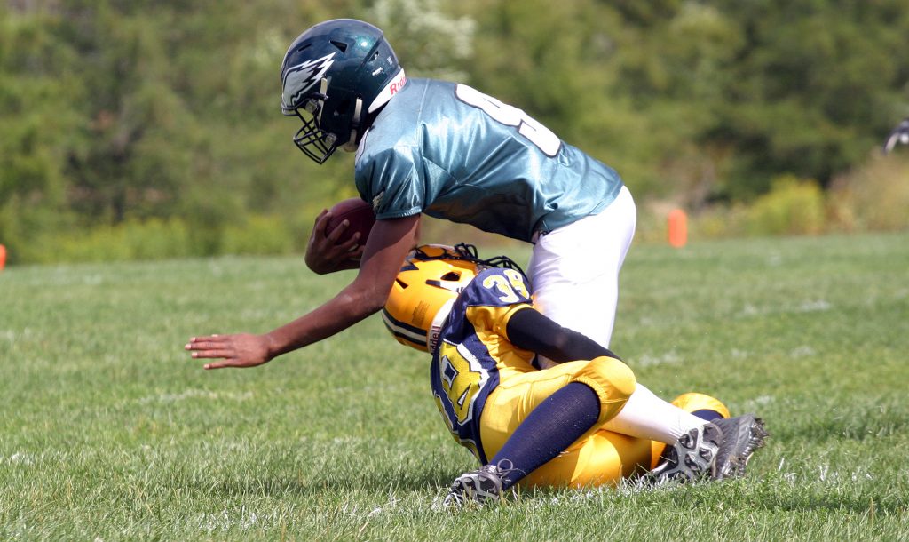 Wolverines DB Mack Thurston makes a tough, open field tackle against the Nepean Eagles earlier in the season. Photo by Jake Davies