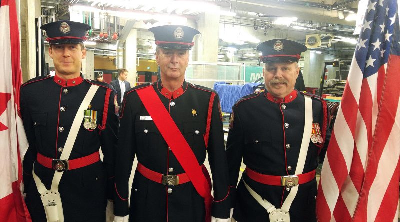 From left, OFS Honour Guards Peter Roy-Smith, Bill Bell and Graham Forrester pose for a photo moments before heading on to Ottawa Senator ice as the colour guard for the evening’s national anthem singing. Photo by Jake Davies
