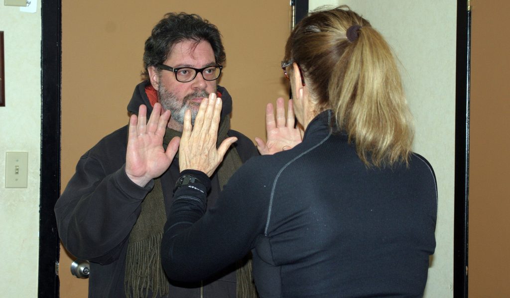 Kathy Fischer works on a running stance drill with a clinic participant last Tuesday, Jan. 14. Photo by Jake Daives