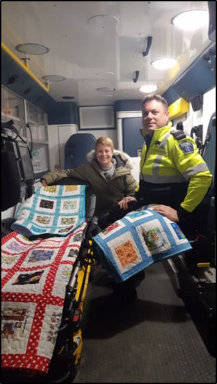 Lanark County paramedic Clint Allan (right) with Almonte Quilters Guild charity coordinator Lisa Compton. Courtesy the AGH