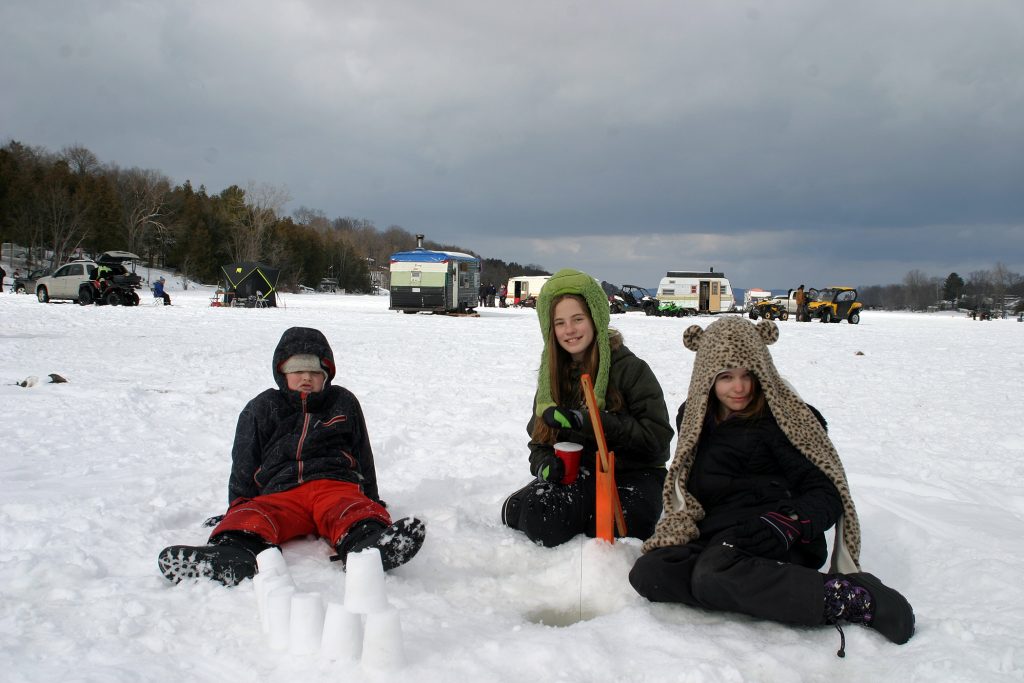 From left, Constance Bay's Geordie Nesbitt, 8, Sophia Efler-Murphy, 11, and Terilyn Nesbitt, 10, all of Constance Bay, watch their hole and build a snow castle. Photo by Jake Davies