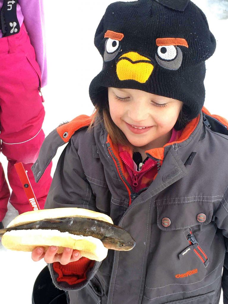 Ruby Forbes shows off a delicious-looking fish sandwich. Photo by Craig Scott