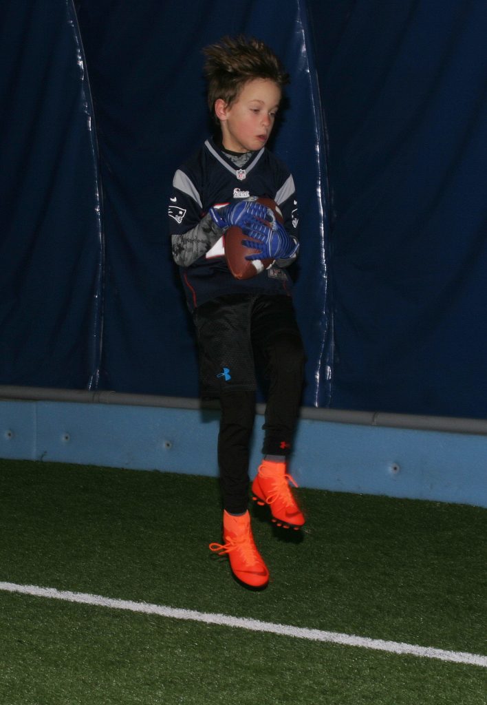 Kanata's Marshall MacKay, 9, shows off his catching skils and his Tom Brady jersey at the Skills and Drills session. Photo by Jake Davies