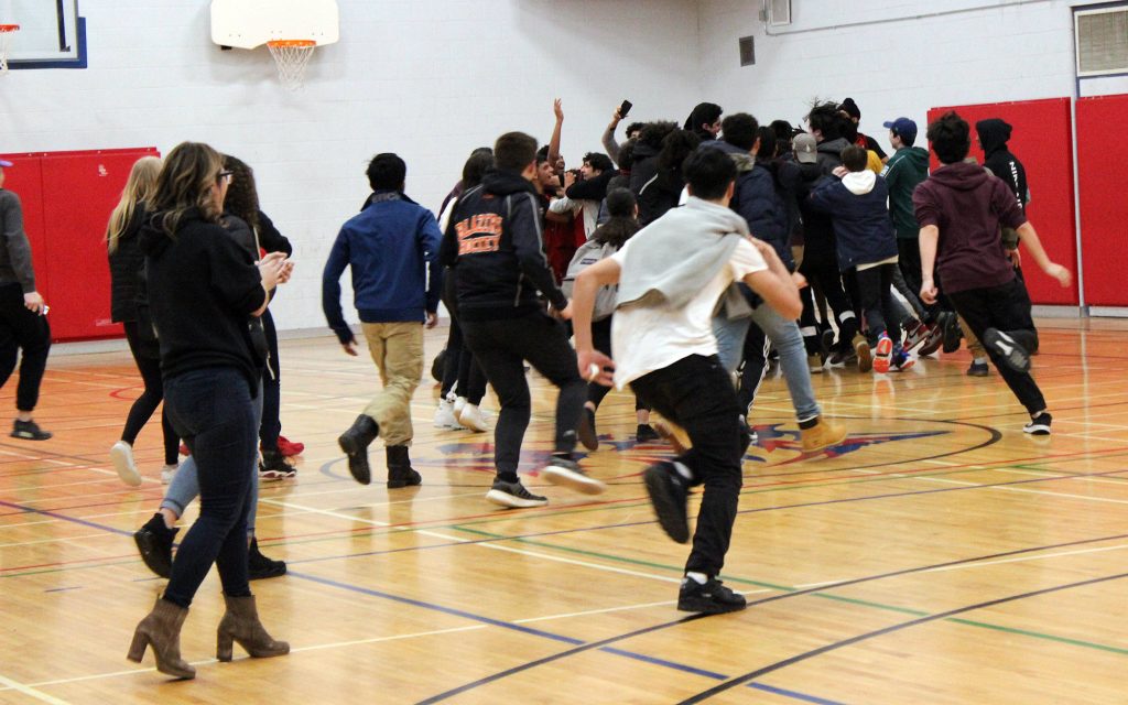 WCSS students storm the court following the final buzzer. Photo by Michelle Russett