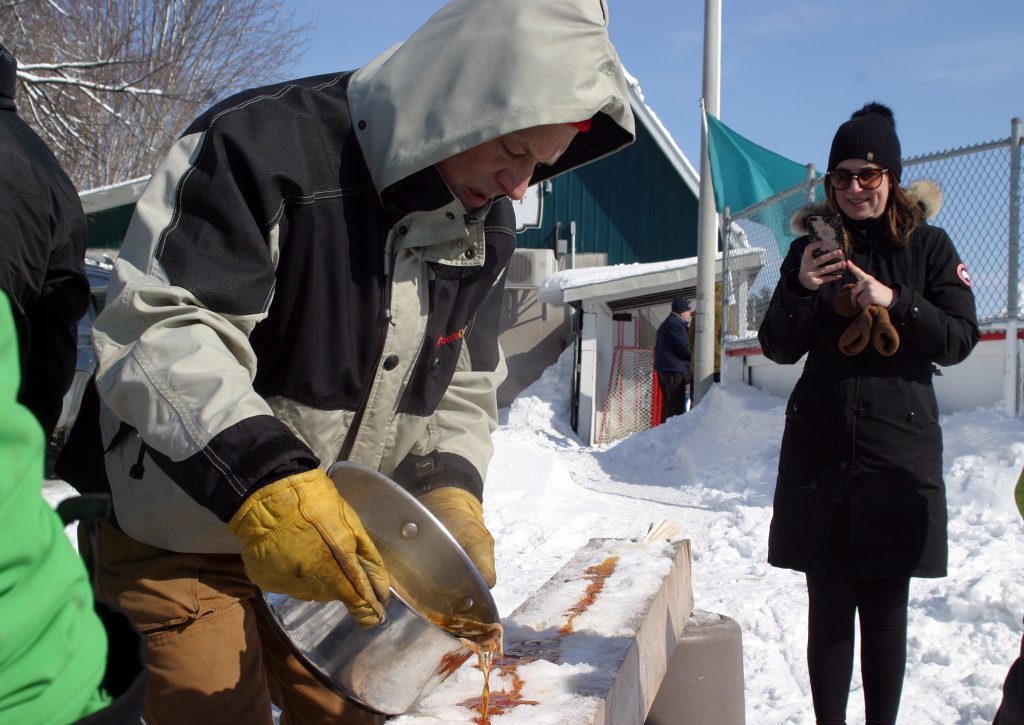 Angus Palmer sets up another round of maple taffy. Photo by Jake Davies