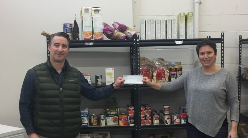 West Carleton P38 Energy branch manager Jeff Girard makes a donation to the Lanark County Food Bank. Courtesy P38 Energy