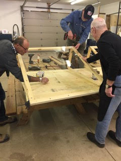 Men's Shed volunteers build protective shields for the hospital's active screeners. Courtesy ARH