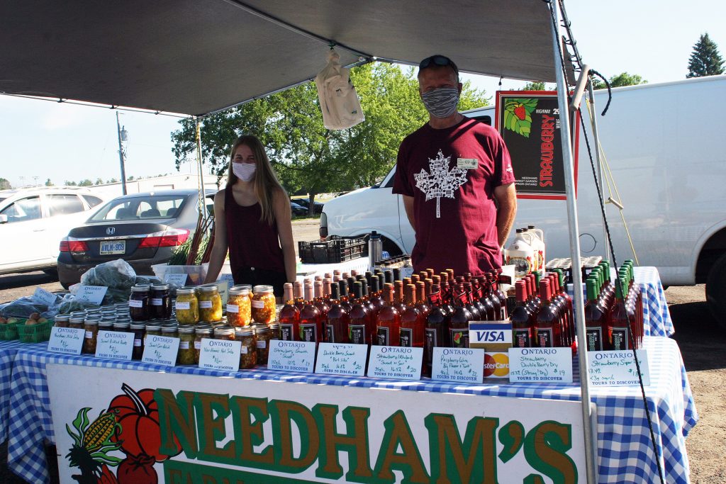 From left, Emma and Glenn Needham from Needham's  Market Garden had some of their famous Hwy. 29 fruit wines on sale. Photo by Jake Davies