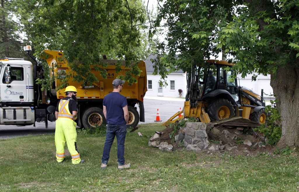 City staff removed two decorative wells in Carp on Wednesday, June 24. Photo by Jake Davies