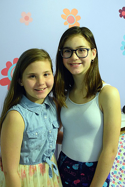 Twin Carp sisters Caitlyn and Isabelle Guibord are big fans of hockey and have even been flag bearers at a Senators game. Courtesy of Katie Buibord