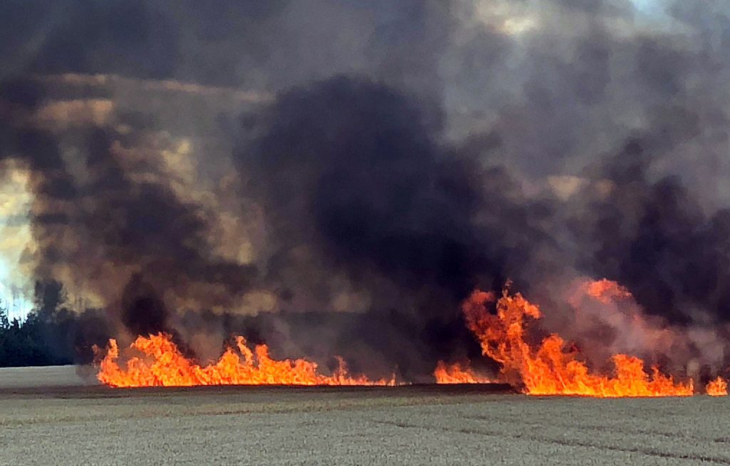 Flames were thick and fast moving, but firefighters were able to protect the farmhouse and other structures on the farm. Photo by Chad Reitsma