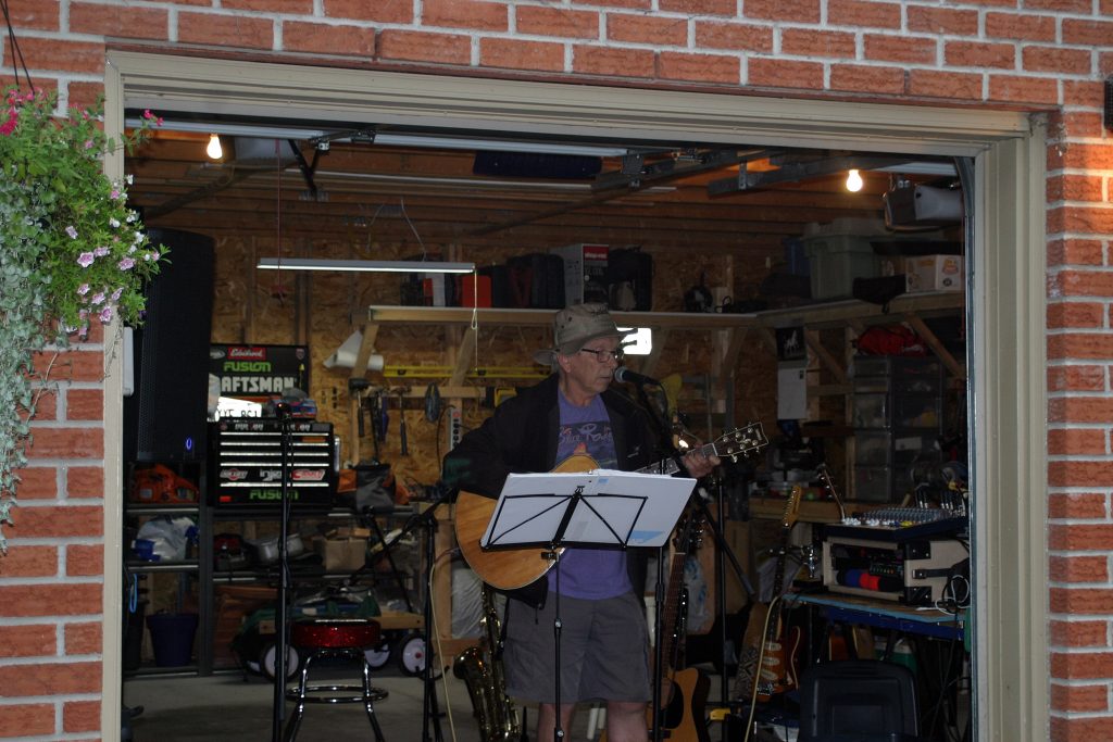 Musician Chris Hearn, a Morris Island resident, performs from the comfort of Jim Murray's garage. Photo by Jake Davies