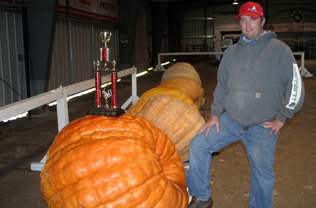 CAS director Charles Caldwell poses with some really big pumpkins.