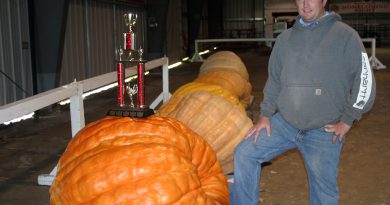 CAS director Charles Caldwell poses with some really big pumpkins.