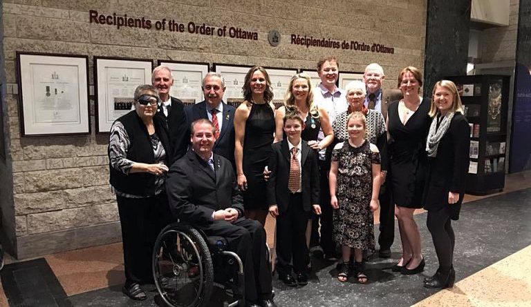 Emily Glossop-Nicholson, family and friends pose for a photo the evening she was honoured with the Order of Ottawa. Photo by Jake Davies