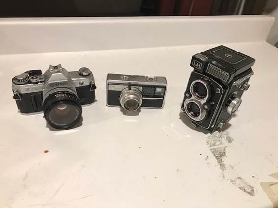 A photo of three different cameras.