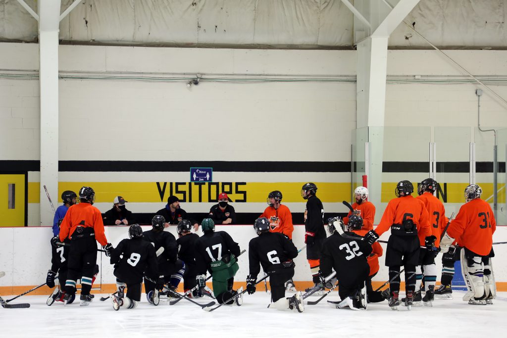 Inferno hopefuls and coaches huddle for a chat during Monday's training camp session.