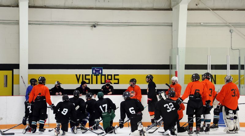 Inferno hopefuls and coaches huddle for a chat during Monday's training camp session.
