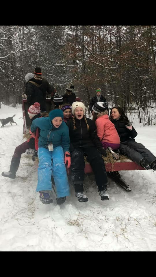 Kids enjoying a sleigh ride.