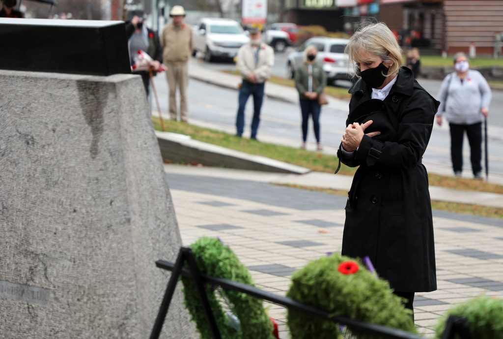 MPP Dr. Merrilee Fullerton lays a wreath during today's ceremony.